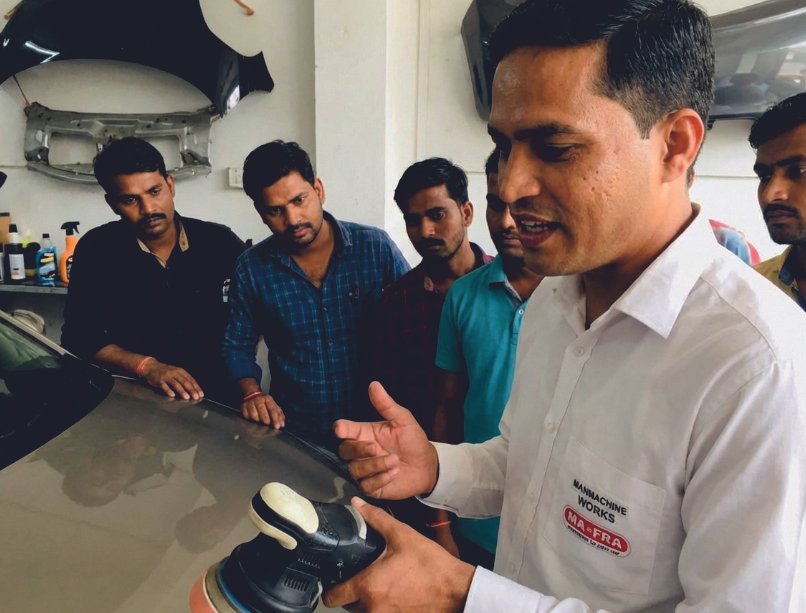 Trainer refining a paint-correction technique